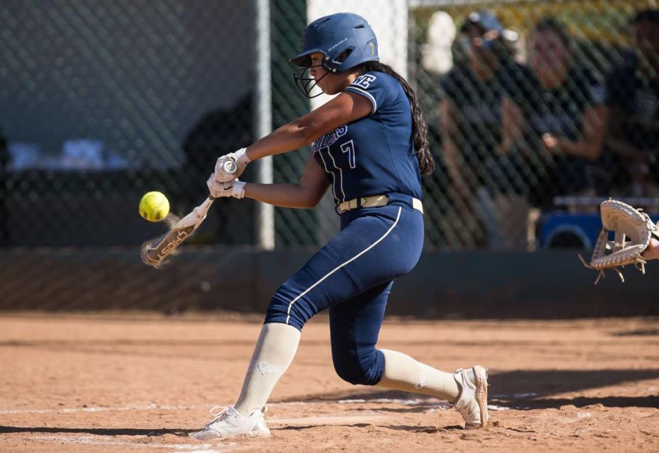 Central Catholic Raiders batter Mya Robles (7) connects for a shallow single to right field against the Ponderosa Bruins during the fourth inning of the CIF Northern California Division III softball championship game Saturday, June 3, 2023, at Ponderosa High School in Shingle Springs.