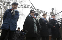 <p>Survivors and guests walk past the “Arbeit Macht Frei” gate at the former Nazi German concentration camp on International Holocaust Remembrance Day in Oswiecim, Poland, Saturday, Jan. 27, 2018. (Photo: Czarek Sokolowski/AP) </p>