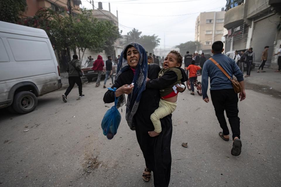 Palestinians evacuate from a site hit by an Israeli bombardment on Rafah, southern Gaza Strip, Wednesday, Dec. 20, 2023.