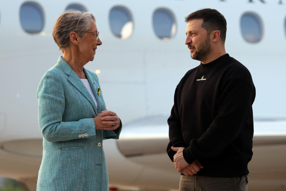 Ukrainian President Volodymyr Zelenskyy is welcomed by French Prime minister Elisabeth Borne upon his arrival at Villacoublay Air Base, southwest of Paris, Sunday, May 14, 2023. Ukrainian President Volodymyr Zelenskyy makes a surprise visit to Paris for talks Sunday night with French President Emmanuel Macron, extending a multi-stop European tour that has elicited fresh pledges of military support as his country gears up for a counteroffensive against Russian occupation forces. (Thomas Samson, Pool via AP)