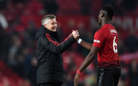 Ole Gunnar Solskjaer, Interim Manager of Manchester United and Paul Pogba of Manchester United celebrate following their sides victory in the Premier League match between Manchester United and Huddersfield Tow - Credit: Getty Images