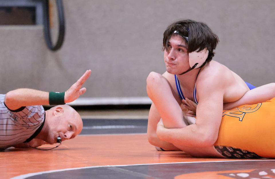 Lake's Xander Carson works to pin Hoover's Connor Stark in their 175 pound match at Hoover ,Thursday, Feb. 9, 2023.