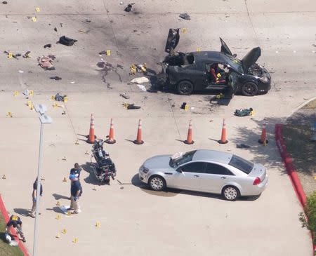 An aerial view shows the area around a car that was used the previous night by two gunmen, who were killed by police, as it is investigated by local police and the FBI in Garland, Texas May 4, 2015. REUTERS/Rex Curry