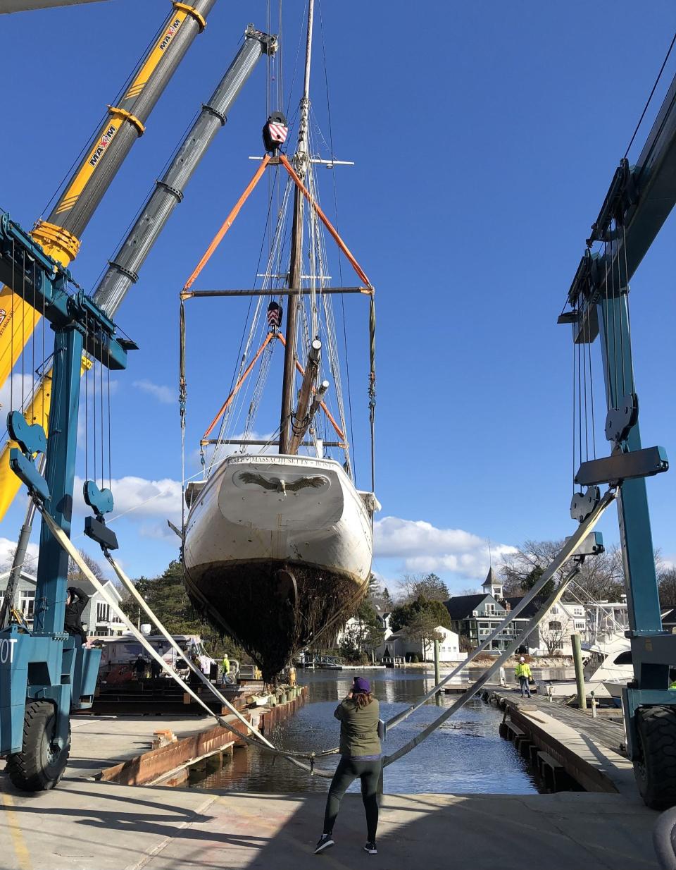 Crews hoist the Spirit of Massachusetts out of the Kennebunk River and onto dry land on Tuesday, Nov. 28, 2023. The move is part of a reconfiguration of the site where a brand new Pilot House restaurant is being built near Dock Square in Kennebunkport, Maine.