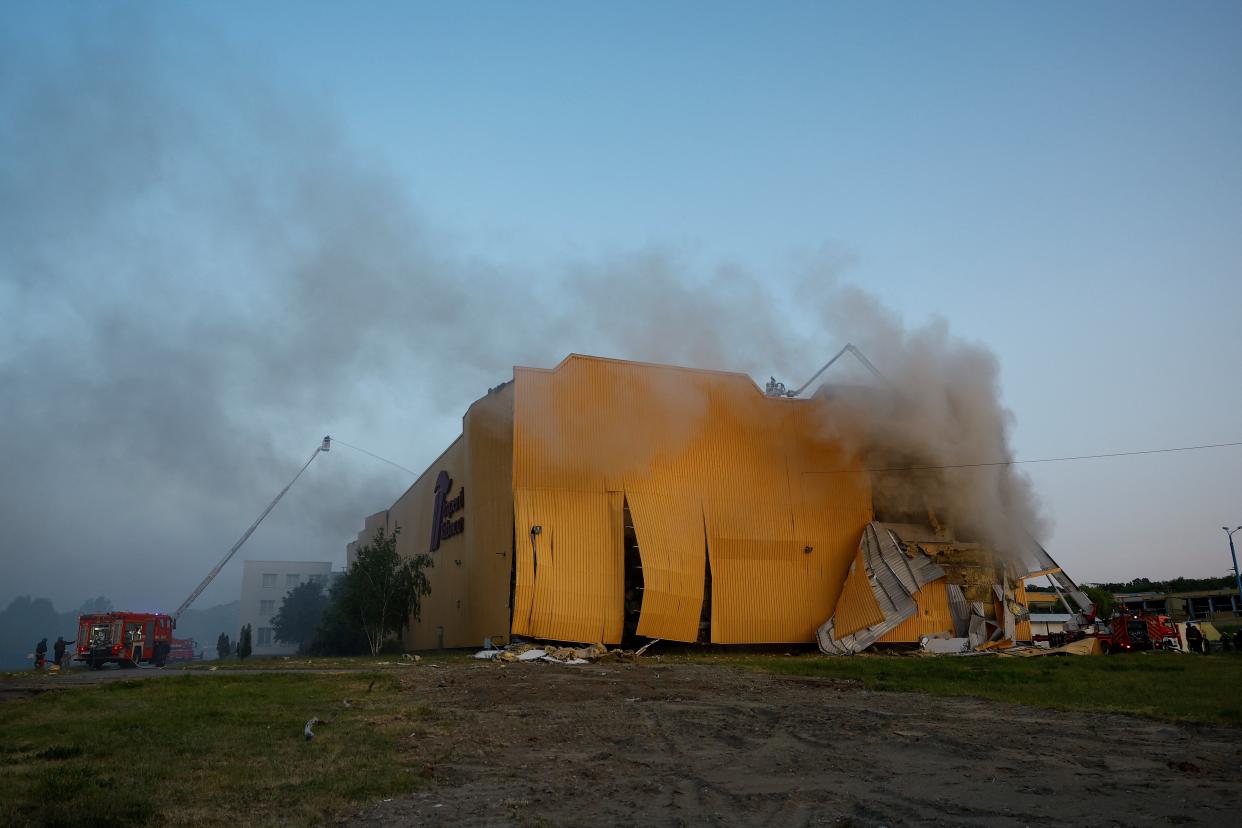 Firefighters work at a site of a tobacco factory damaged during Russian suicide drone strike, amid Russia’s attack on Ukraine, in Kyiv, Ukraine 28 May 2023 (Reuters)