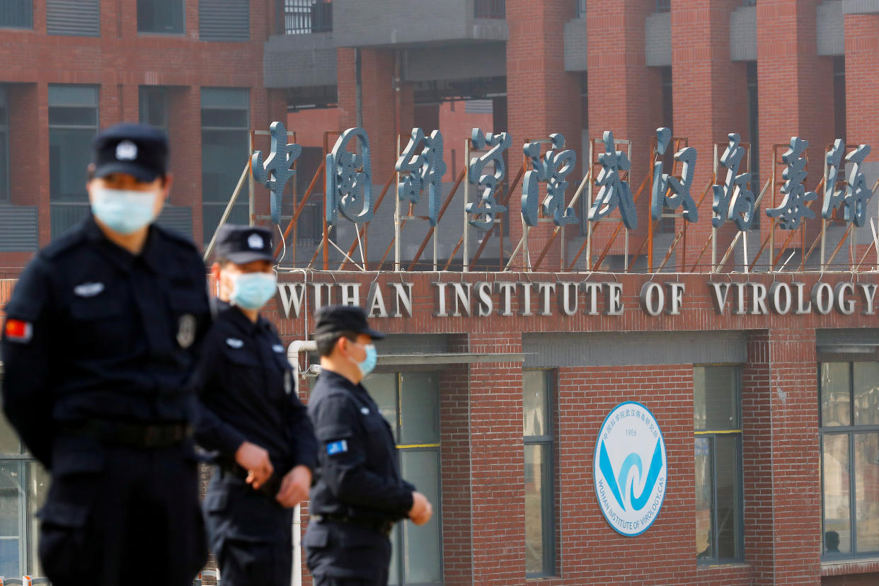 Security personnel keep watch outside the Wuhan Institute of Virology during the visit by the World Health Organization (WHO) team tasked with investigating the origins of the coronavirus disease (COVID-19), in Wuhan, Hubei province, China February 3, 2021. REUTERS/Thomas Peter