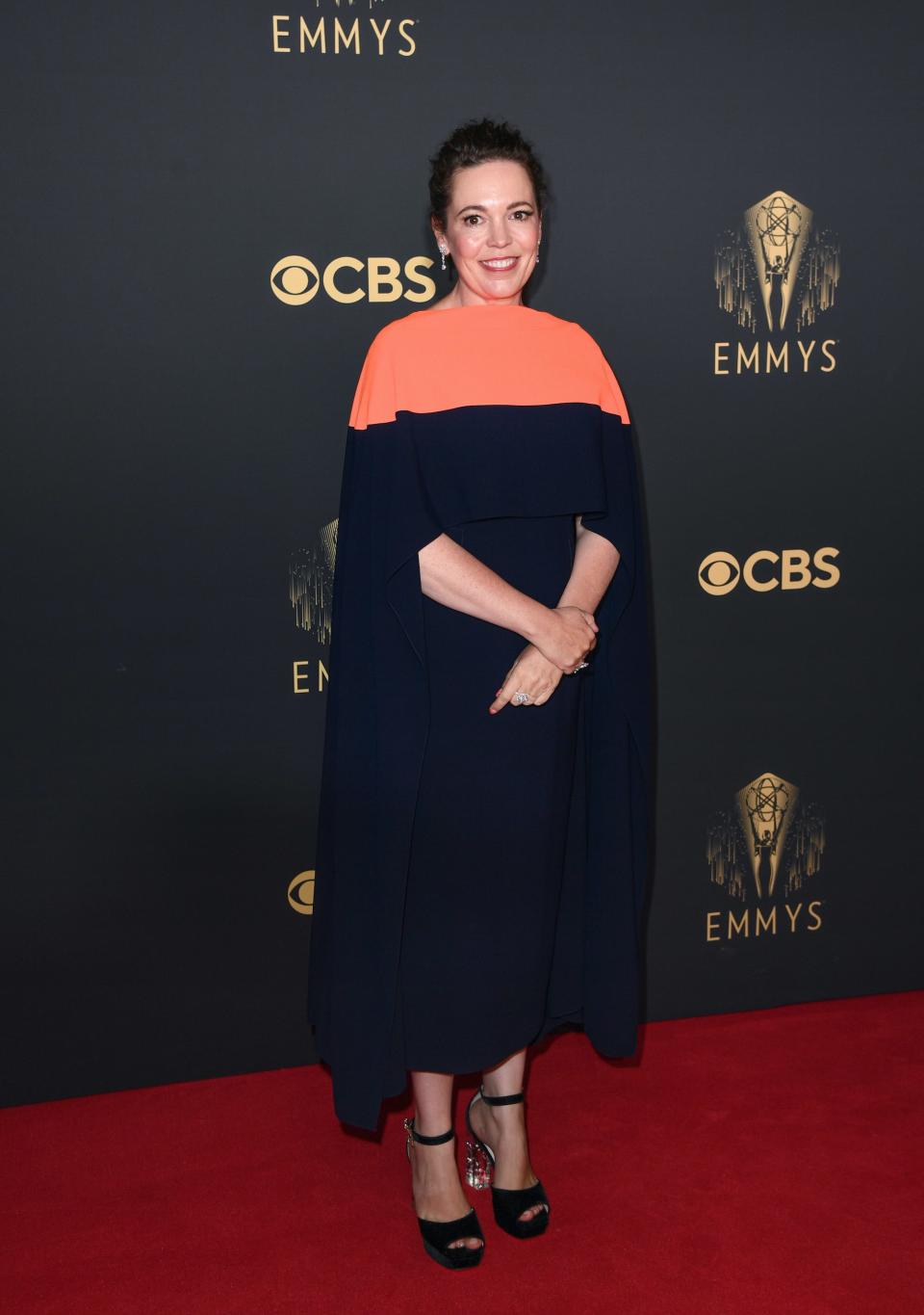 Olivia Colman wears a blue and orange dress on the Emmys red carpet.