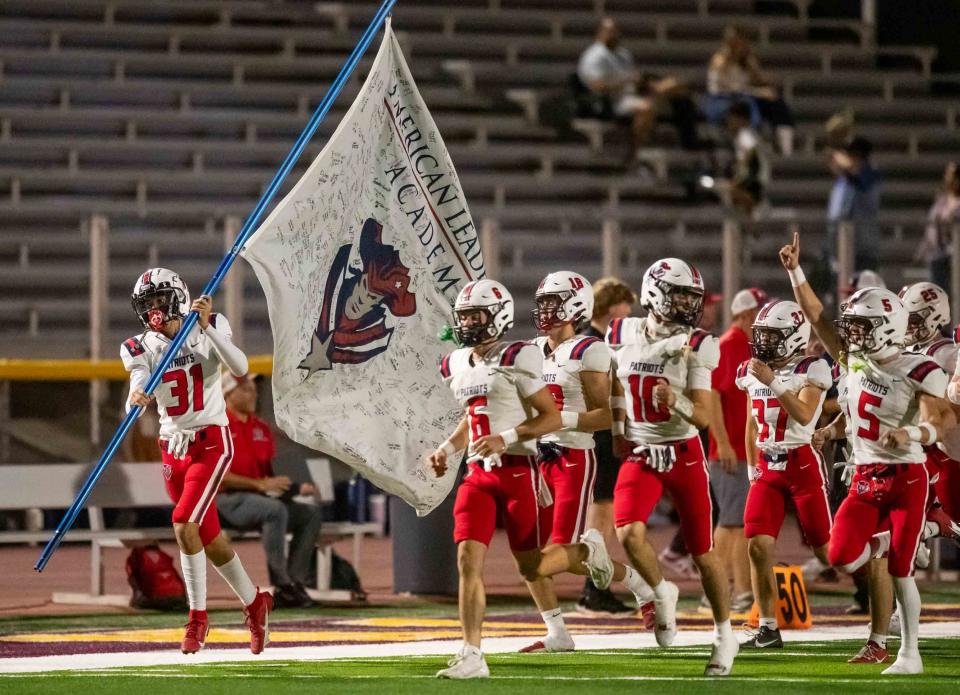 Sep 29, 2023; Phoenix, AZ, USA; American Leadership Academy Patriots run onto the field at Mountain Pointe High SchoolÕs football field in Phoenix on Sept. 29, 2023.