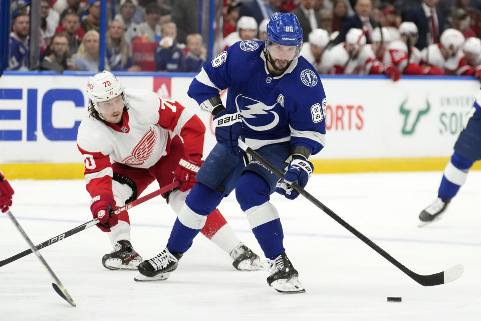 Tampa Bay Lightning right wing Nikita Kucherov (86) moves around Detroit Red Wings center Oskar Sundqvist (70) during the second period of an NHL hockey game Tuesday, Dec. 6, 2022, in Tampa, Fla. (AP Photo/Chris O'Meara)