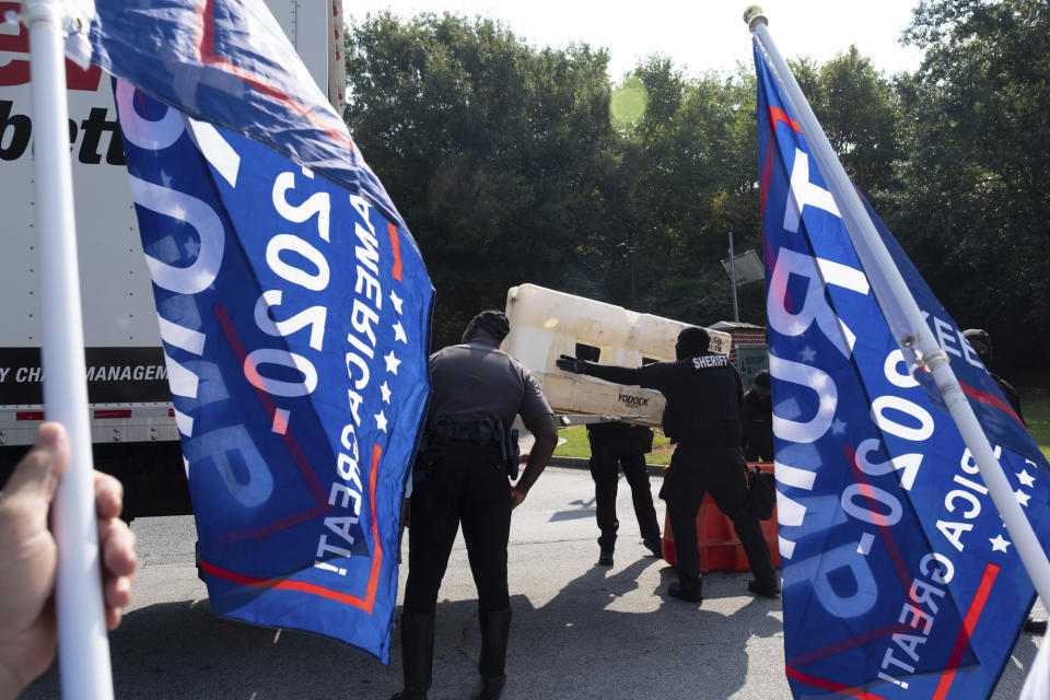 Officials set up barriers in front of the Fulton County jail as supporters of former President Donald Trump gather, Thursday, Aug. 24, 2023. (AP Photo/Ben Gray)