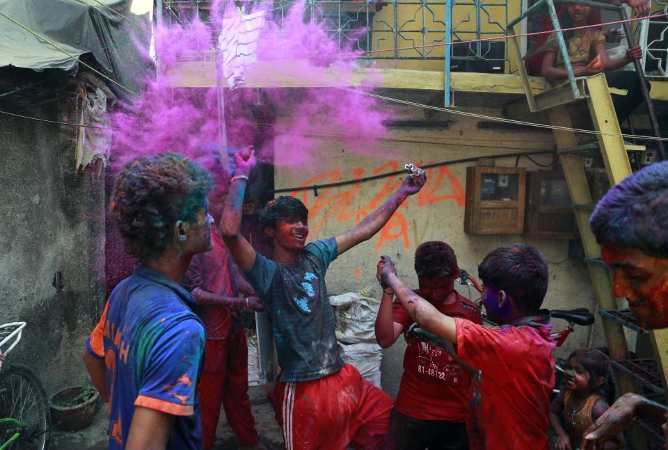 Indian children play with colored powder to celebrate Holi, the Hindu festival of colors, in Mumbai India, Monday, March 17, 2014. The festival also heralds the arrival of spring. (AP Photo/ Rafiq Maqbool)