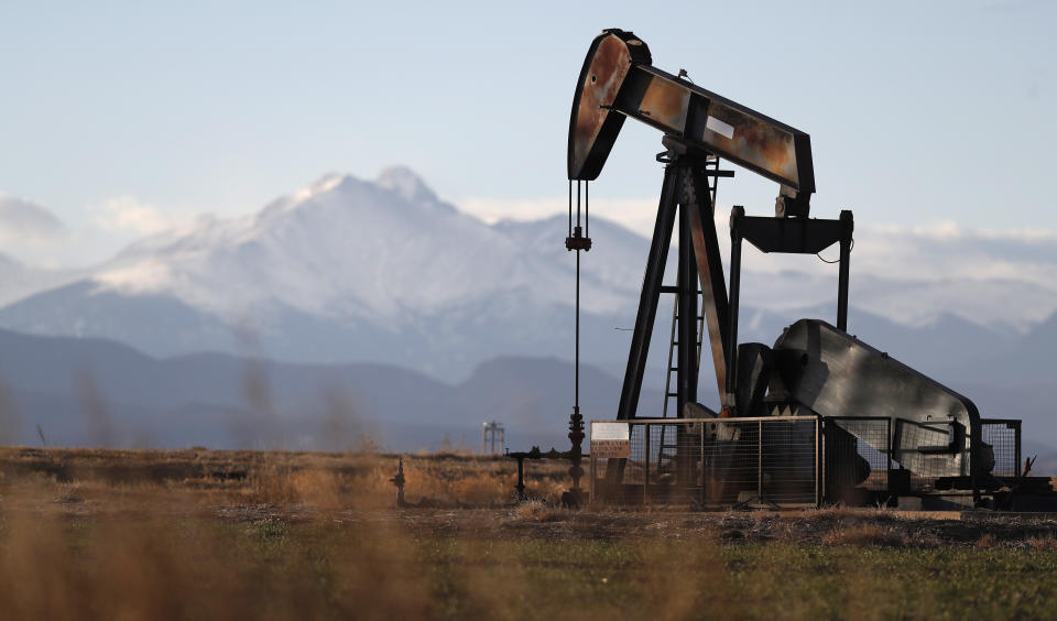 FILE - This Dec. 22, 2018, file photo shows a pump jack over an oil well along Interstate 25 near Dacono, Colo. Federal courts have delivered a string of rebukes to the Trump administration over what they found were failures to protect the environment and address climate change as it promotes fossil fuel interests and the extraction of natural resources from public lands. (AP Photo/David Zalubowski, File)