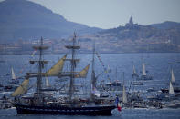 The Belem, the three-masted sailing ship which is carrying the Olympic flame, is accompanied by other boats approaching Marseille, southern France, Wednesday, May 8, 2024. After leaving Marseille, a vast relay route is undertaken before the torch odyssey ends on July 27 in Paris. The Paris 2024 Olympic Games will run from July 26 to Aug.11, 2024. (AP Photo/Daniel Cole)