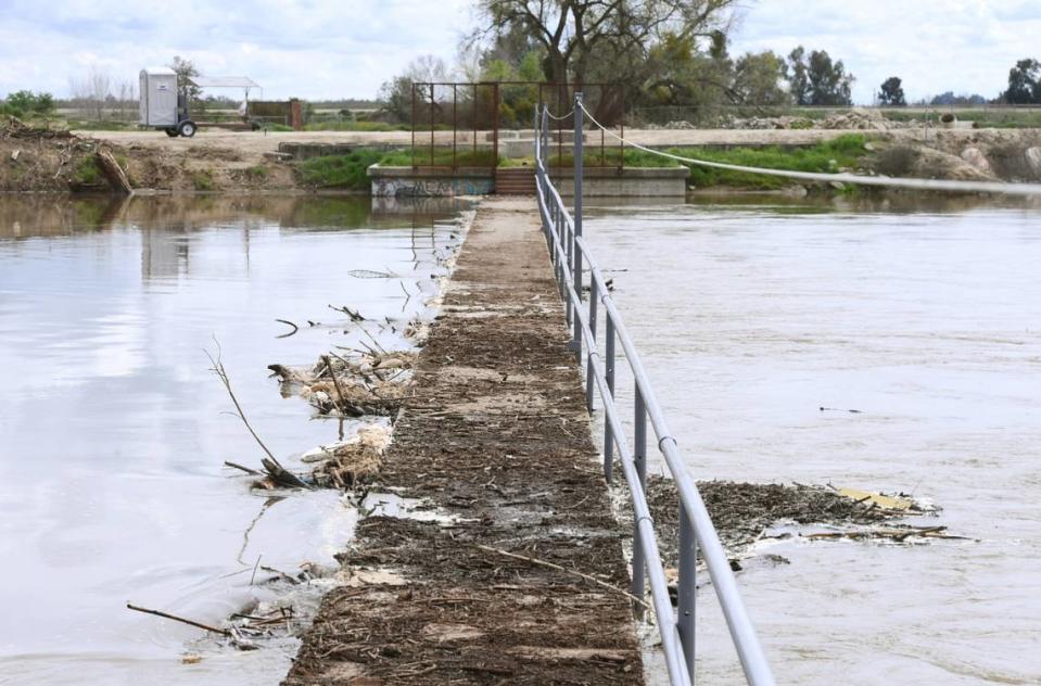 A fork of the lower Kings River flows through and almost tops Crescent Weir south of Riverdale, in southern Fresno County, before turning northwest Monday afternoon, March 20, 2023.