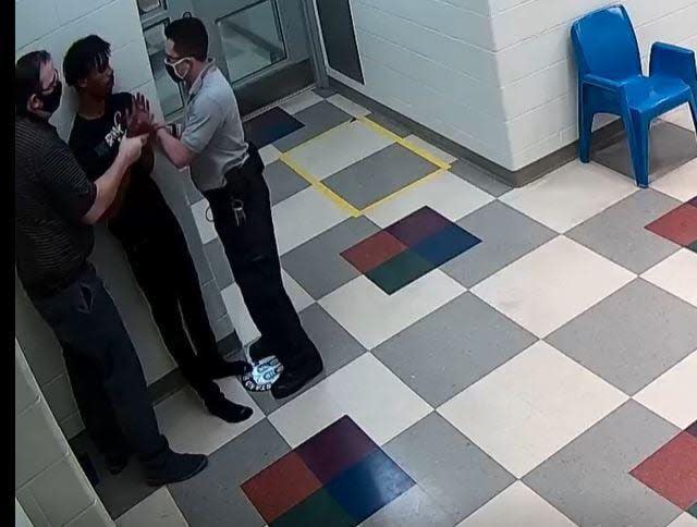 This still image from a security camera provided by Sedgwick County shows Cedric “CJ” Lofton struggling with staff on Sept. 24, 2021 at the Sedgwick County Juvenile Intake and Assessment Center in Wichita, Kan. Sedgwick County released 18 video clips late Friday, Jan. 21, 2022, of what happened before Lofton was rushed to a hospital on Sept. 24. He died two days later. (Sedgwick County via AP)