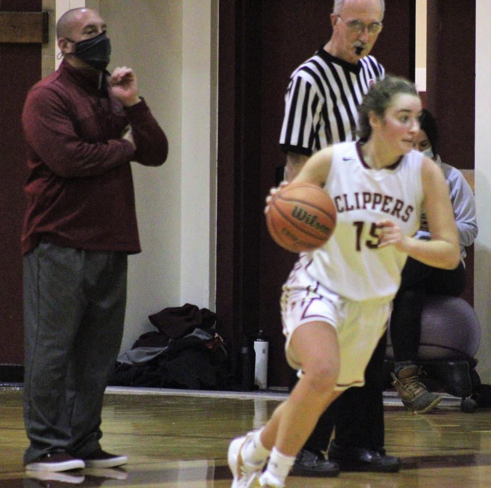 Portsmouth High School sophomore Margaret Montplaisir drives to the hoop as head coach Tim Hopley watches during Friday's 54-27 win over Winnacunnet.