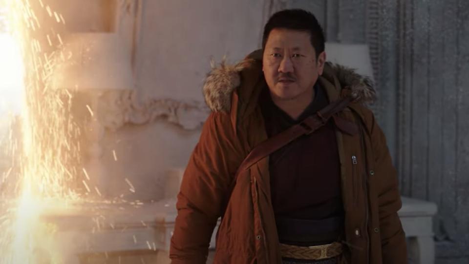 Wong wears winter clothes next to a portal