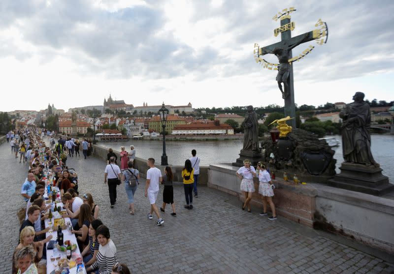 Residents dine at the medieval Charles Bridge in Prague