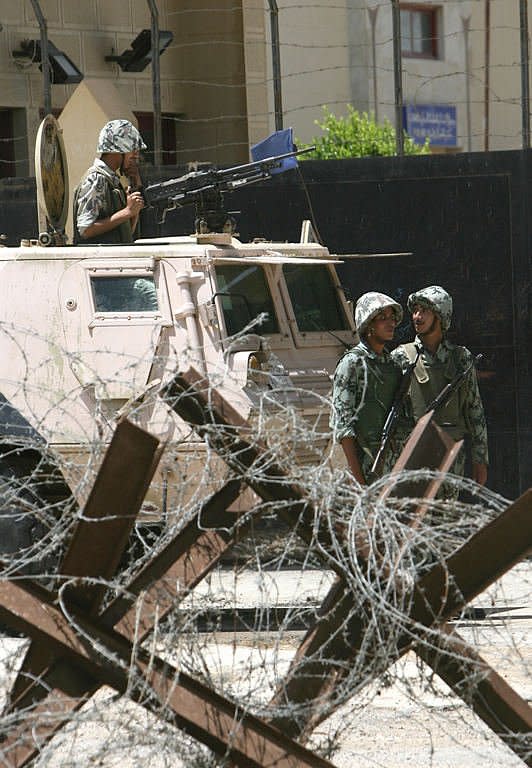 Egyptian soldiers stand guard at the crossing between Egypt and the Rafah border in the southern Palestinian Gaza Strip. Egypt on Saturday reopened its Rafah border crossing with Gaza, allowing people to cross freely for the first time in four years, in a move hailed by Hamas but criticised by Israel