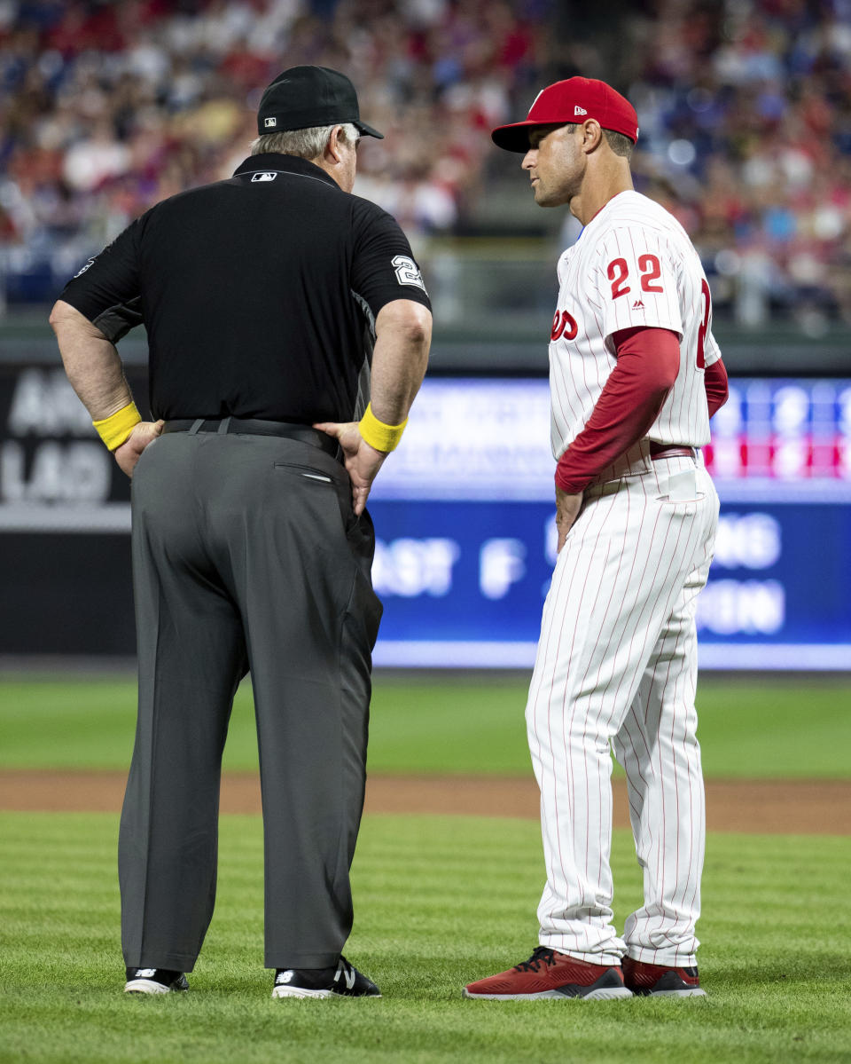 Umpire Joe West, left, talks with Philadelphia Phillies manager Gabe Kapler, right, about the situation with relief pitcher Austin Davis during the eighth inning of a baseball game against the Chicago Cubs, Saturday, Sept. 1, 2018, in Philadelphia. West confiscated a card from Davis. Davis and Phillies manager Gabe Kapler said he was using the card merely for information on the Cubs hitters. But West said it was illegal under Rule 6.02(c)(7), which states that the pitcher shall not have on his person, or in his possession, any foreign substance. The Cubs won 7-1. (AP Photo/Chris Szagola)