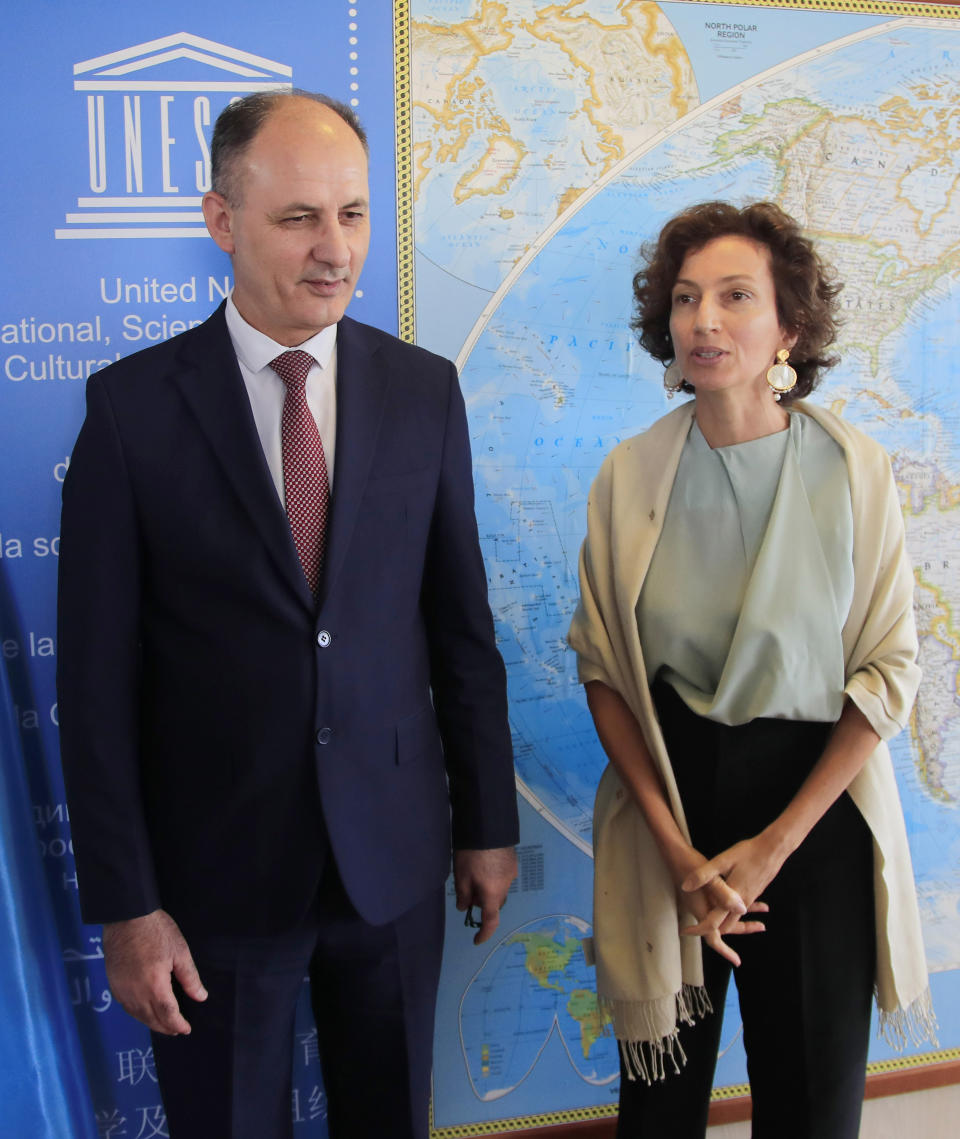 Iraq's Culture Minister Abdulamir al-Dafar Hamdani, left, is welcomed by UNESCO'S Director-General Audrey Azoulay at the UNESCO's headquarters in Paris, Wednesday, Sept. 11. 2019. Iraqi officials meet at the UN's cultural agency in Paris to discuss plans for an ambitious $100 million reconstruction of the Islamic State-ravaged city of Mosul. (AP Photo/Michel Euler) HAMDANI