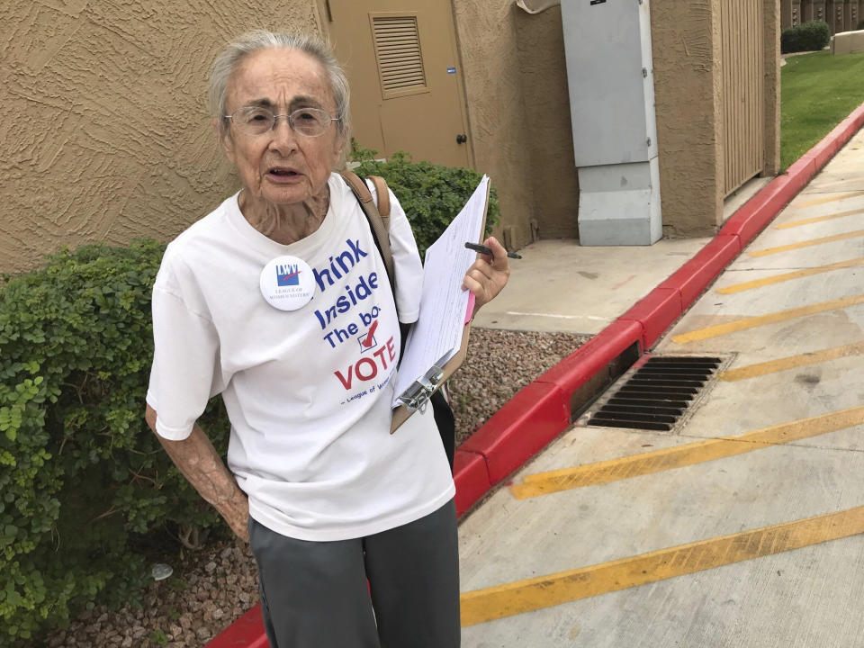 FILE - In this April 19, 2018 file photo, Rivko Knox, a volunteer with the League of Women Voters, collects signatures for a campaign financing ballot measure outside a polling station in Glendale, Ariz. A judge on Friday, Aug. 24, 2018 upheld a 2016 Arizona law that bans groups from collecting early mail-in ballots from voters and delivering them. The ruling dismissed a legal challenge to the law filed by Knox. (AP Photo/Anita Snow, File)