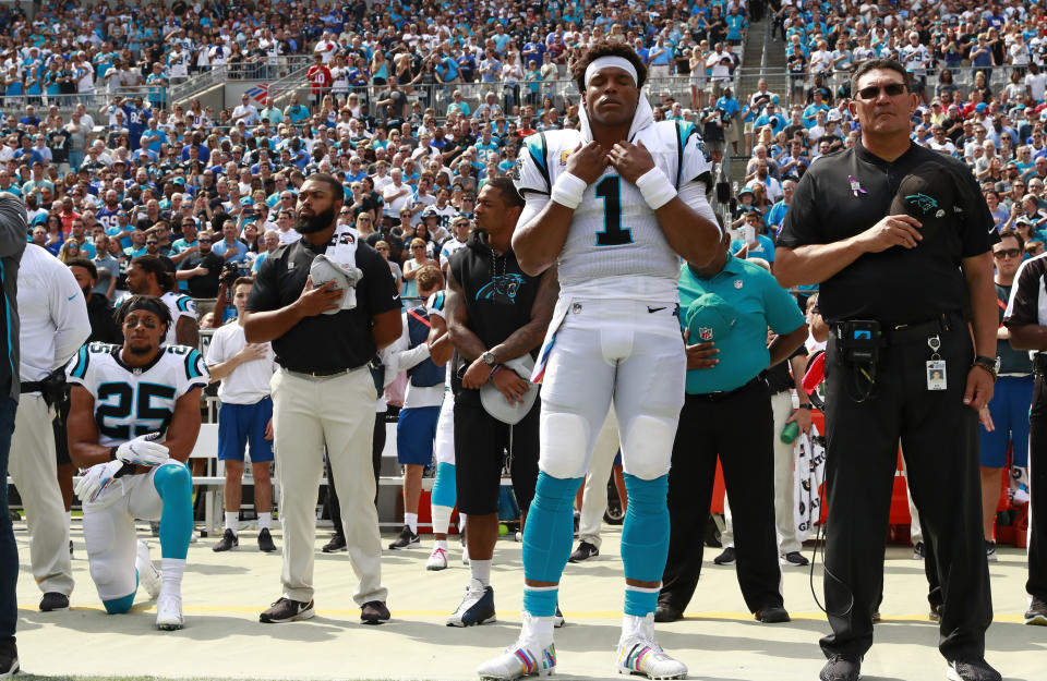 Cam Newton, center, coach Ron Rivera, right, and the rest of the Carolina Panthers are featured on Amazon's new season of "All or Nothing." (AP)