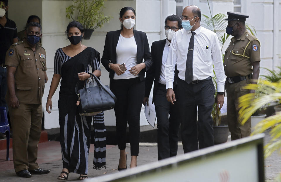 Former Mrs. Sri Lanka 2019 and current Miss World Caroline Jurie (C) leaves Cinnamon Gardens Police Station after being released on bail in Colombo on  April 8, 2021 following her arrest on charges of assault over an on-stage fracas in which she pulled the crown off the head of the new 