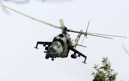 A Ukrainian helicopter Mi-24 gunship flies above a military base in the eastern Ukrainian town of Kramatorsk August 22, 2014. REUTERS/Valentyn Ogirenko
