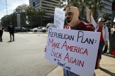 Rob Adler protests against President Trump's proposed replacement for Obamacare in Los Angeles, California, U.S., March 14, 2017. REUTERS/Lucy Nicholson