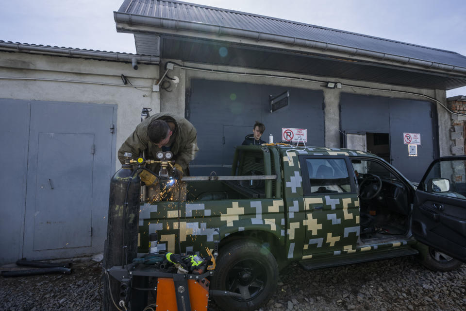 Car welder Ostap Datsenko, 31, works on a vehicle that will be sent to soldiers on the frontlines, at a welding workshop in Lviv, western Ukraine, Sunday, March 27, 2022. “Our victory depends on us,” says Datsenko. (AP Photo/Nariman El-Mofty)