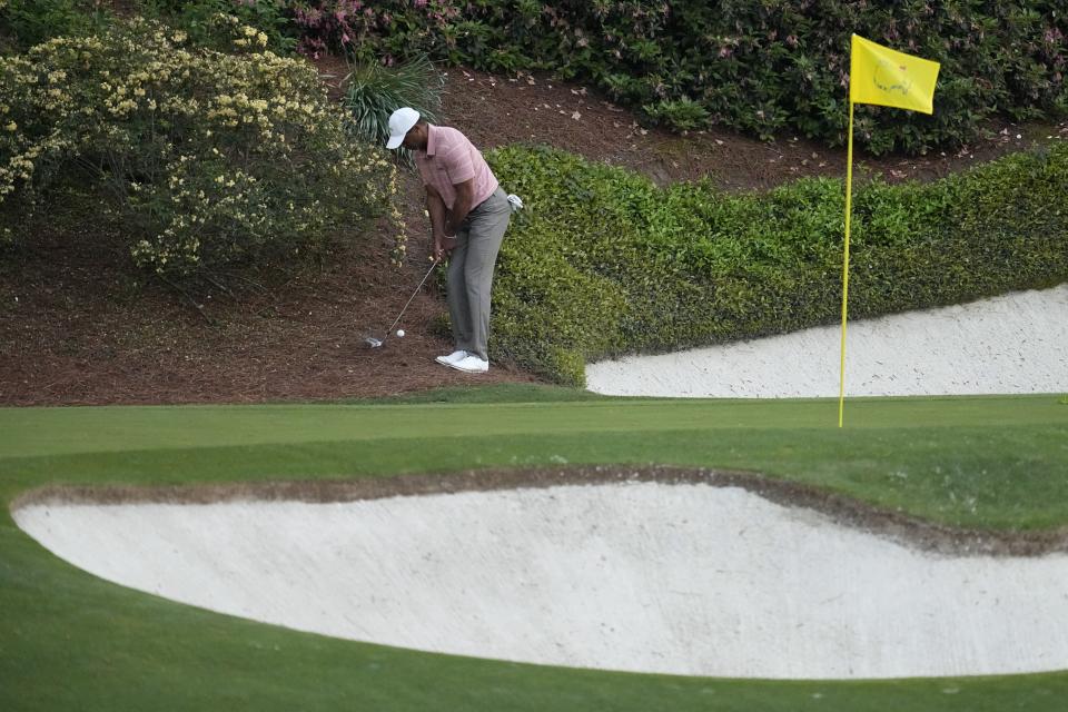 Tiger Woods hits from the pine straw on the 12th hole during the first round at the Masters golf tournament at Augusta National Golf Club Thursday, April 11, 2024, in Augusta, Ga. (AP Photo/George Walker IV)