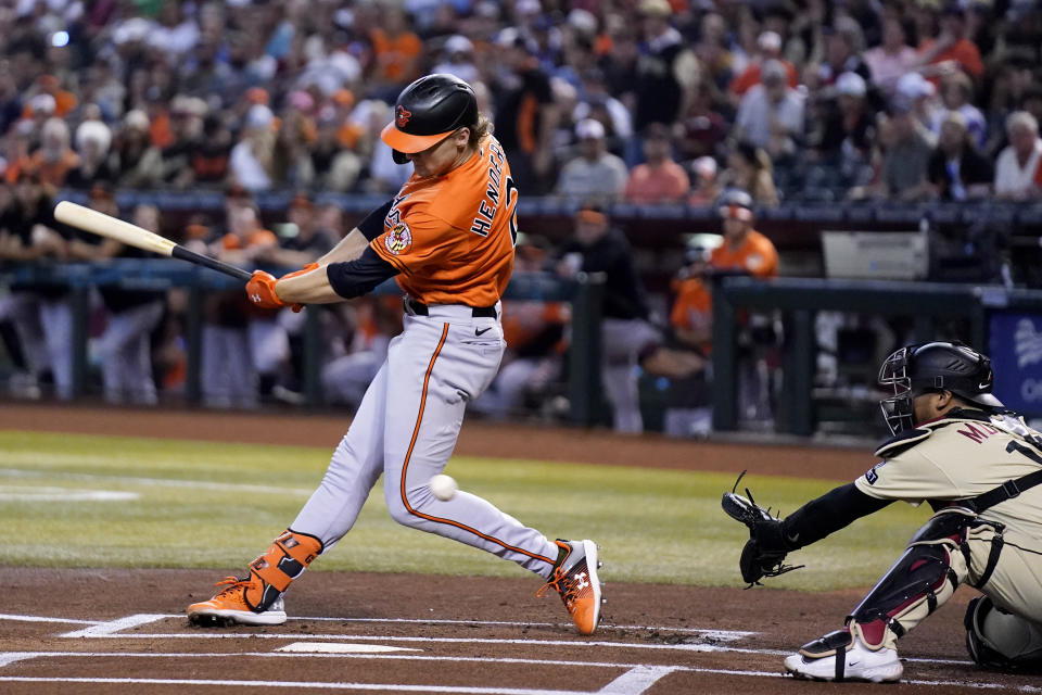 Baltimore Orioles' Gunnar Henderson, left, strikes out as Arizona Diamondbacks catcher Gabriel Moreno reaches for the ball during the first inning of a baseball game Saturday, Sept. 2, 2023, in Phoenix. (AP Photo/Ross D. Franklin)