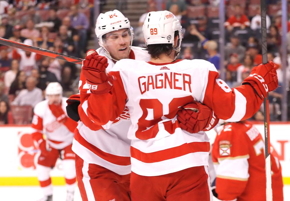 Red Wings center Pius Suter congratulates center Sam Gagner on his goal during the first period on Thursday, April 21, 2022, in Sunrise, Florida.