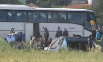 Police watch as refugees and migrants board buses to be tranferred to government camps, during an operation to evacuate a makeshift camp at the Greek-Macedonian border near the village of Idomeni, Greece, May 24, 2016. REUTERS/Ognen Teofilovski