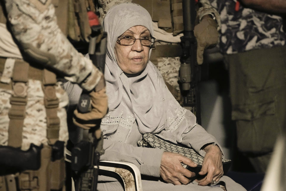 Saudi commandos guard a wheelchair evacuee before to board Al-Jubail military ship to Jeddah port, at Port Sudan in Sudan, Wednesday, May 3, 2023. Many are fleeing the conflict in Sudan between the military and a rival paramilitary force. (AP Photo/Amr Nabil)