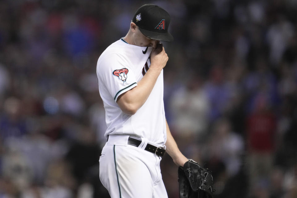 Arizona Diamondbacks relief pitcher Paul Sewald leaves the field after the top of the ninth inning in Game 5 of the baseball World Series against the Texas Rangers Wednesday, Nov. 1, 2023, in Phoenix. (AP Photo/Godofredo A. Vásquez)