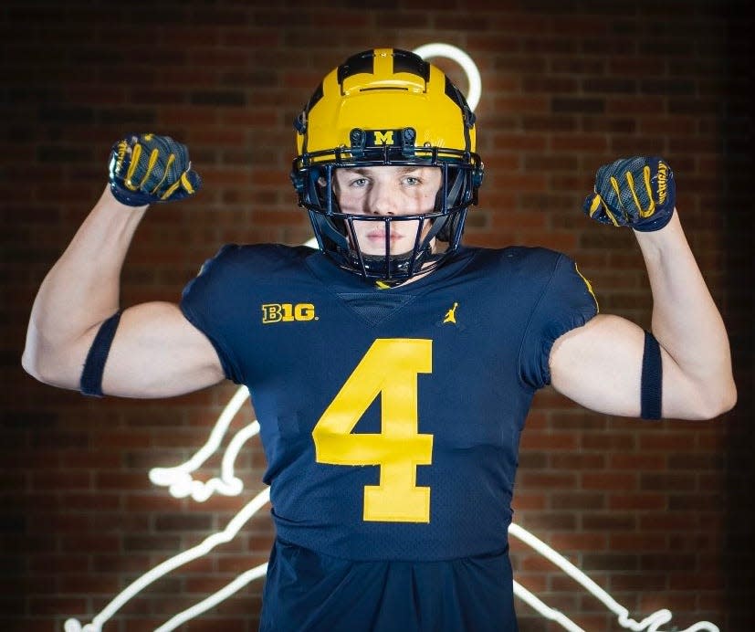 Millbrook native Andrew Rappleyea poses in a University of Michigan football uniform during his recruiting trip in December. The Milton Academy junior verbally committed to Michigan on Sunday.