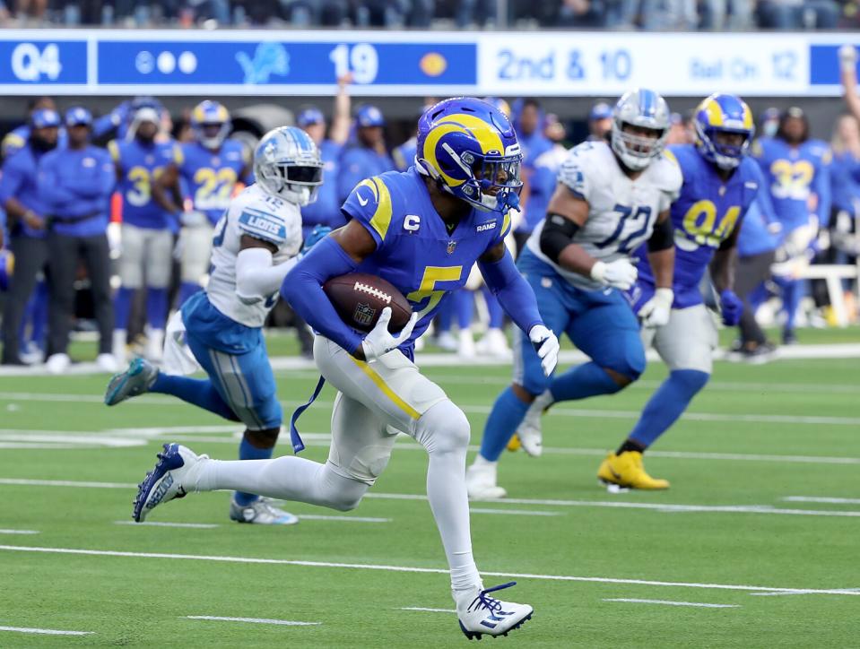 Rams cornerback Jalen Ramsey runs with the ball after intercepting a pass by Lions quarterback Jared Goff.