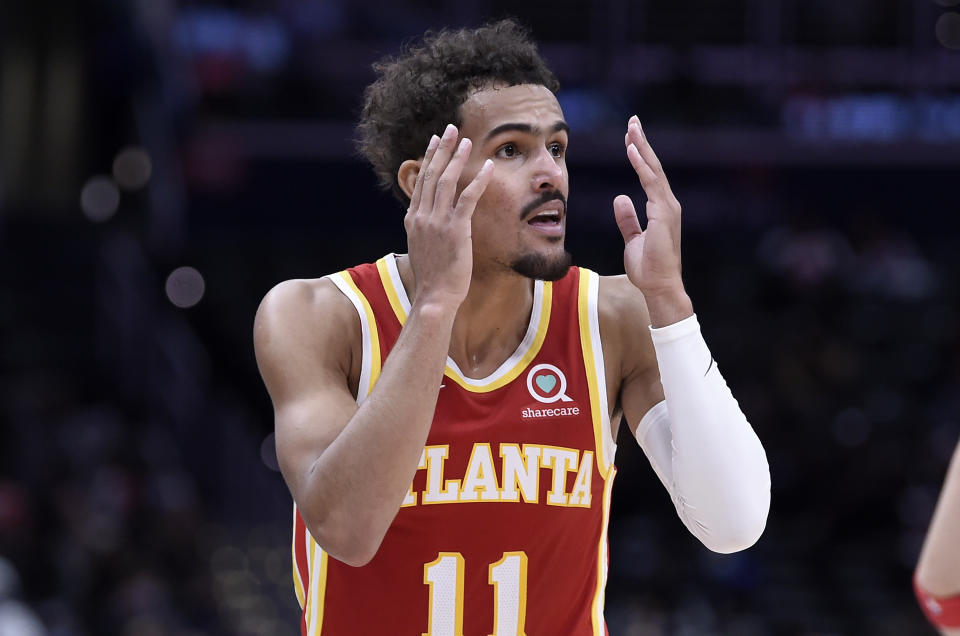 Trae Young reacts to a call with his hands up near his head and a look of disbelief on his face.