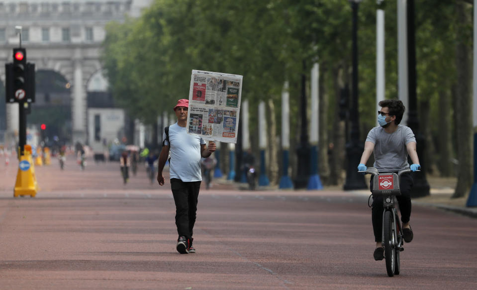 People cycle and jog along The Mall in London, Sunday, May 10, 2020, during the nation-wide coronavirus lockdown. Personal exercise while observing social distancing measures is allowed under government lockdown guidelines. (AP Photo/Frank Augstein)