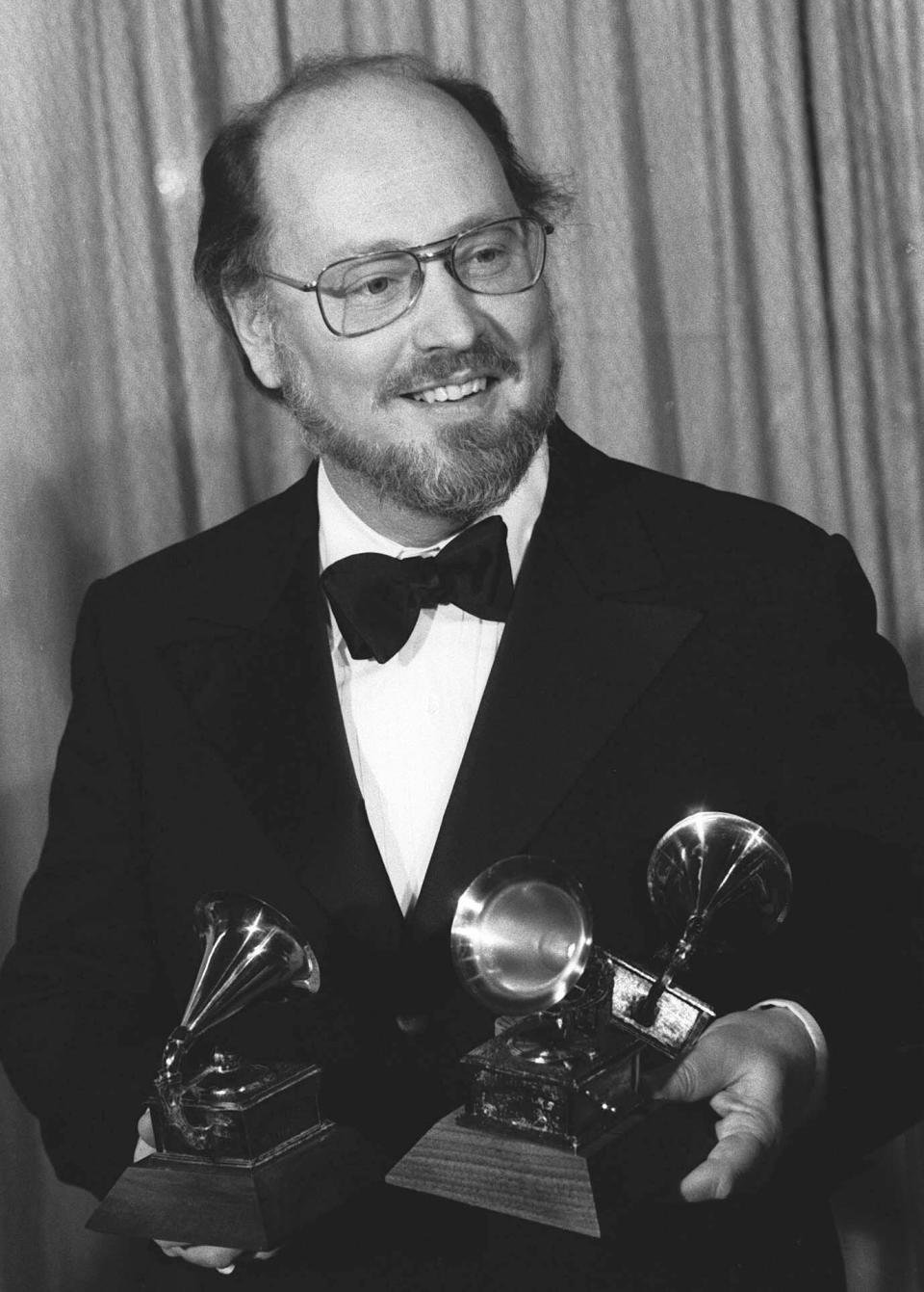 FILE - Composer and conductor John Williams holds three Grammy Awards he won for best original score, best instrumental composition and best pop instrumental recording for his work on the film "Star Wars" in Los Angeles on Feb. 23, 1978. (AP Photo, File)