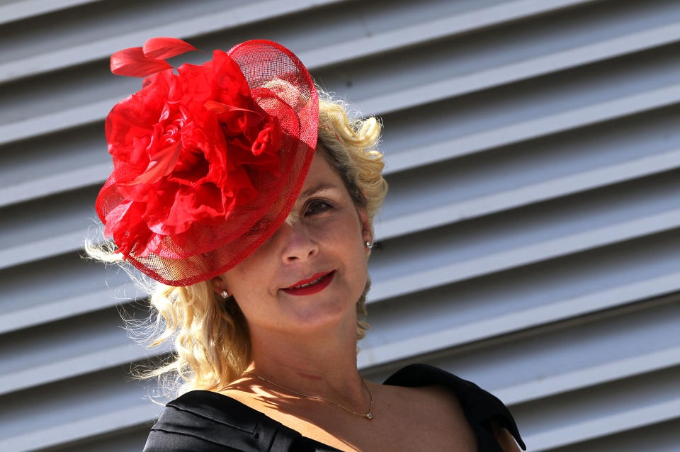 A racegoer poses for photographers on 'Ladies Day' on the first day of the Epsom Derby Festival in Surrey, southern England, on June 3, 2011. The Epsom Derby race will be run Saturday June 4, 2011.   AFP PHOTO / ADRIAN DENNIS (Photo credit should read ADRIAN DENNIS/AFP/Getty Images)