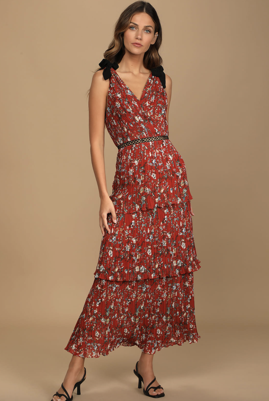 brunette model in Such Sophistication Rust Red Floral Print Pleated Maxi Dress in Red Floral Print (Photo via Lulus)