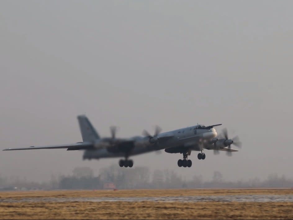 A Russian Tu-95MS strategic bomber takes off in an unknown location to perform a flight over the neutral waters of the Sea of Japan (Russian defence ministry/Reuters)