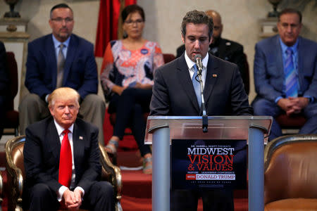 Republican presidential nominee Donald Trump listens as his personal attorney Michael Cohen delivers remarks on his behalf during a campaign stop at the New Spirit Revival Center church in Cleveland Heights, Ohio, U.S. September 21, 2016. REUTERS/Jonathan Ernst/Files