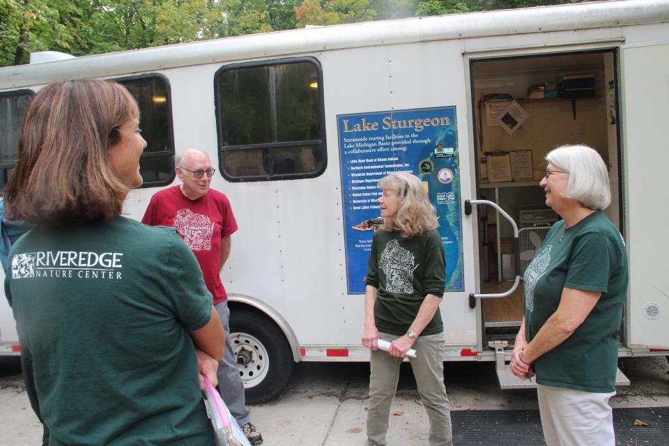 Mary Holleback of Riveredge Nature Center, second from right, speaks Sept. 21 with volunteers (from left) Sue Herron, Fred Rusch and Wendy Jabas, all of Cedarburg, at the facility's sturgeon rearing trailer in Saukville.