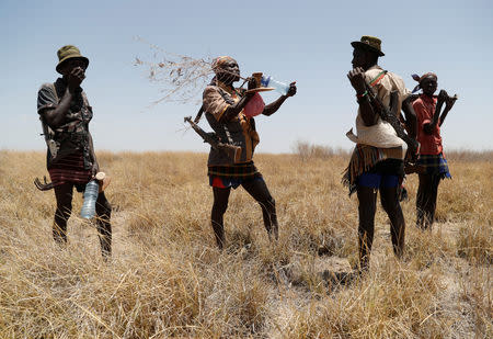 Turkana warriors patrol with guns to protect their cattle from a Dassenach warrior near Todonyang, Kenya March 21, 2019. REUTERS/Goran Tomasevic