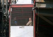 <p>Taking an elevator up the side of a building while filming a movie in 2003. </p>