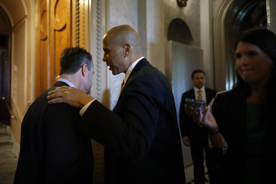 WASHINGTON, DC - JULY 19: Sen. Todd Young (R-IN) (L) talks Sen. Cory Booker (D-NJ) just outside the Senate Chamber at the U.S. Capitol on July 19, 2022 in Washington, DC. Young, a key United States Innovation and Competition Act supporter who is working to insert commerce and national security provisions into the bill, said that fellow Republicans are now pushing to grow the Chips for America Act, which is designed to strengthen the U.S. semiconductor industry and reduce dependence on Chinese and Taiwanese manufacturers. 